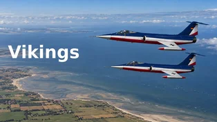 Zwei blau-weiß-rote F‑104G Starfighter der Vikings fliegen in Formation über der Küste Schleswig-Holsteins
